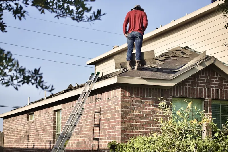 Professional roofer working on a residential roof in Russiaville